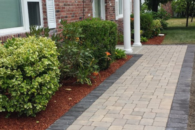 This is an example of a mid-sized full sun front yard stone landscaping in Boston.