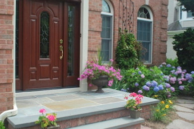 Design ideas for a large traditional full sun front yard concrete paver landscaping in New York.