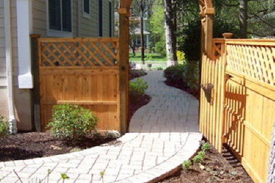 Inspiration for a large traditional full sun side yard concrete paver landscaping in New York.