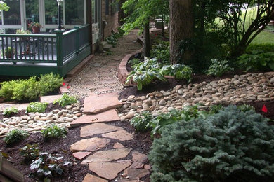 Design ideas for a traditional shade side yard stone landscaping in St Louis for summer.