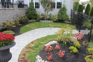 Design ideas for a mid-sized side yard brick garden path in Philadelphia.