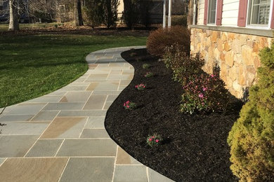 Inspiration for a large traditional front full sun garden for autumn in Philadelphia with a garden path and natural stone paving.