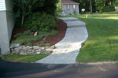 This is an example of a large side yard stone landscaping in Boston.