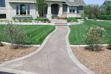 Inspiration for a large traditional partial sun front yard concrete paver garden path in Minneapolis.