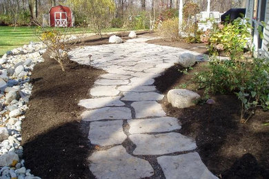 Inspiration for a full sun side yard concrete paver garden path in Newark.