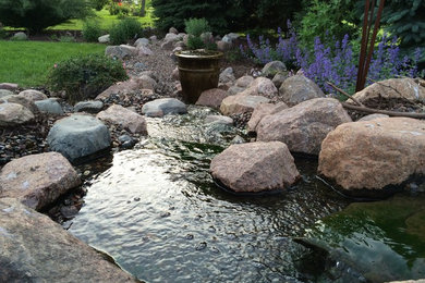 Design ideas for a large rustic shade backyard gravel pond in Other for spring.