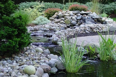 Inspiration for a large backyard stone water fountain landscape in Bridgeport.