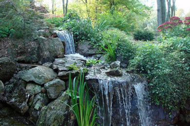 Inspiration for a mid-sized partial sun backyard water fountain landscape in New York.