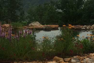 Inspiration for a large classic garden in Orange County with a pond.