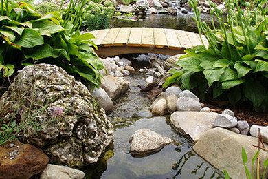 Inspiration for a traditional backyard stone landscaping in Toronto.