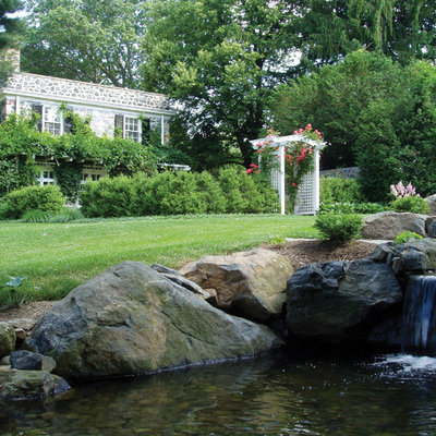 Inspiration for a mid-sized traditional partial sun courtyard stone landscaping in Philadelphia.