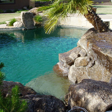 Waterfall into a pool with palm trees surrounding