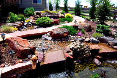 Design ideas for a huge asian full sun backyard stone landscaping in Denver for summer.
