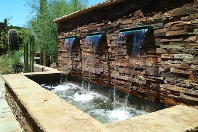 Design ideas for a large rustic full sun backyard stone water fountain landscape in Phoenix.