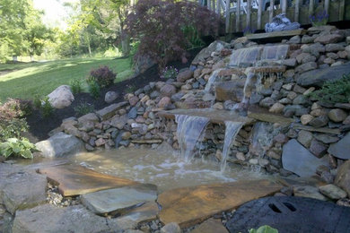 Design ideas for a large shade side yard stone water fountain landscape in Cincinnati.