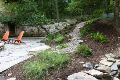 Design ideas for an expansive rustic sloped garden for summer in New York with natural stone paving and a garden path.