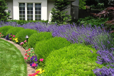 Photo of a mid-sized full sun front yard landscaping in Portland for summer.
