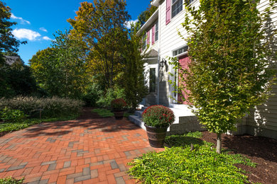 Design ideas for a huge traditional partial sun front yard concrete paver driveway in Boston.