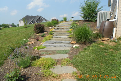 This is an example of a mid-sized rustic hillside stone landscaping in Baltimore.