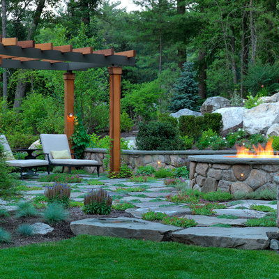 Design ideas for a large traditional backyard stone landscaping in Boston with a fire pit.
