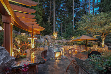 Inspiration for a rustic partial sun backyard landscaping in Vancouver.