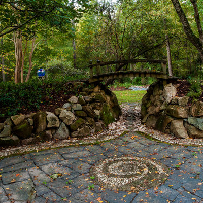 Photo of a traditional rock backyard stone landscaping in Raleigh.