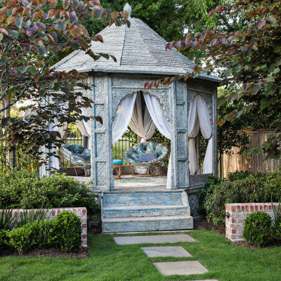 Design ideas for a mid-sized traditional partial sun backyard stone formal garden in Houston.