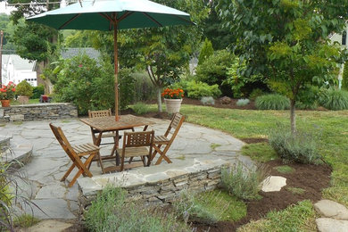 Design ideas for a large traditional partial sun backyard stone formal garden in Bridgeport.