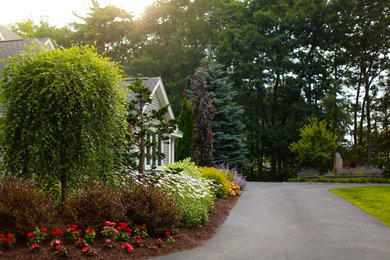 This is an example of a mid-sized traditional full sun front yard landscaping in Boston for summer.