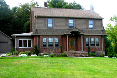 This is an example of a large traditional front yard concrete paver landscaping in Boston.