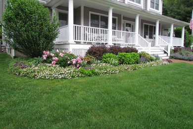 This is an example of a large traditional partial sun brick retaining wall landscape in Boston.