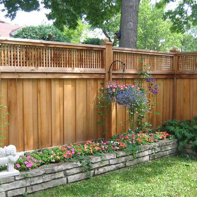 Design ideas for a large transitional partial sun backyard wood fence formal garden in Minneapolis.