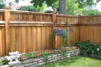 Design ideas for a large transitional partial sun backyard wood fence formal garden in Minneapolis.