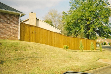 Photo of a mid-sized traditional full sun backyard landscaping in New Orleans.