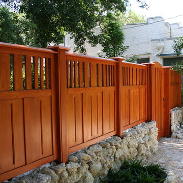 Wood gate with fencing plus landscaping and hardscape .