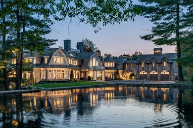 Design ideas for a large traditional front garden with a pond.