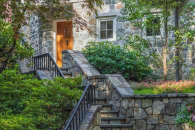 Photo of a mid-sized traditional partial sun side yard stone landscaping in New York for summer.
