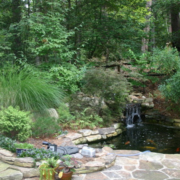 Woodland Pond with Stone Paving and Seating Walls