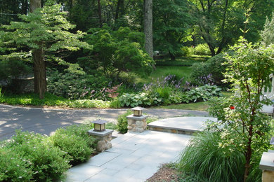 Large traditional side driveway fully shaded garden in New York with natural stone paving.