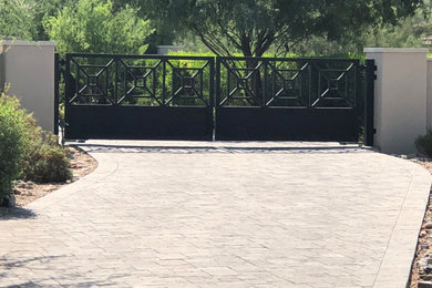 This is an example of a contemporary front yard brick driveway in Phoenix.