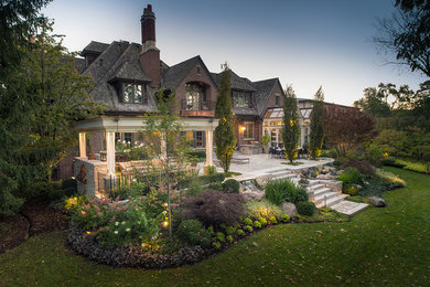 Photo of a traditional backyard stone landscaping in Toronto with a fire pit.