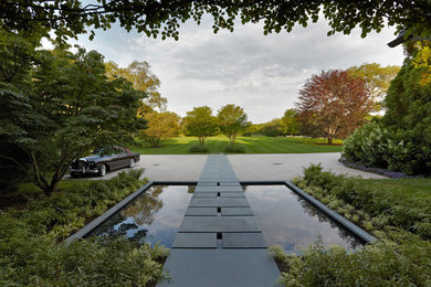 Aménagement d'un jardin contemporain avec un point d'eau, une exposition partiellement ombragée et du gravier.