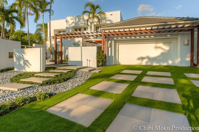 Inspiration for a large contemporary front yard concrete paver landscaping in Miami.