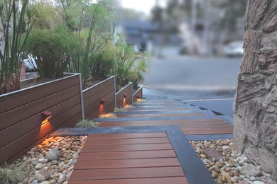 Design ideas for a mid-sized asian full sun front yard landscaping in Orange County with decking.