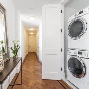 Example of a small trendy single-wall ceramic tile laundry closet design in New York with a stacked washer/dryer