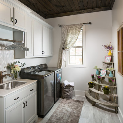 Dedicated laundry room - mid-sized country single-wall ceramic tile dedicated laundry room idea in New Orleans with an undermount sink, a side-by-side washer/dryer and recessed-panel cabinets