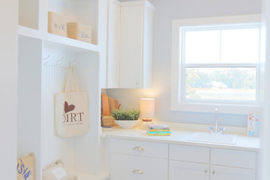 Laundry room - farmhouse laundry room idea in Milwaukee with an utility sink, white cabinets, quartz countertops, gray walls and a side-by-side washer/dryer