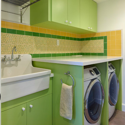 Dedicated laundry room - mid-sized contemporary single-wall concrete floor and gray floor dedicated laundry room idea in San Francisco with an utility sink, flat-panel cabinets, green cabinets, quartz countertops, white walls, a side-by-side washer/dryer and white countertops