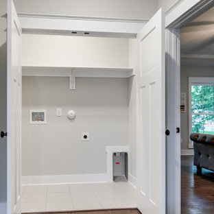 Inspiration for a large country single-wall medium tone wood floor and brown floor laundry closet remodel in Richmond with gray walls and a side-by-side washer/dryer