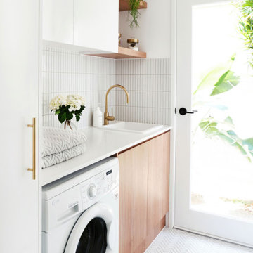 A white Smartstone benchtop helps a Queensland laundry